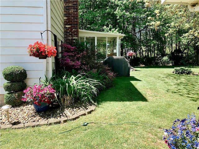 view of yard featuring a sunroom