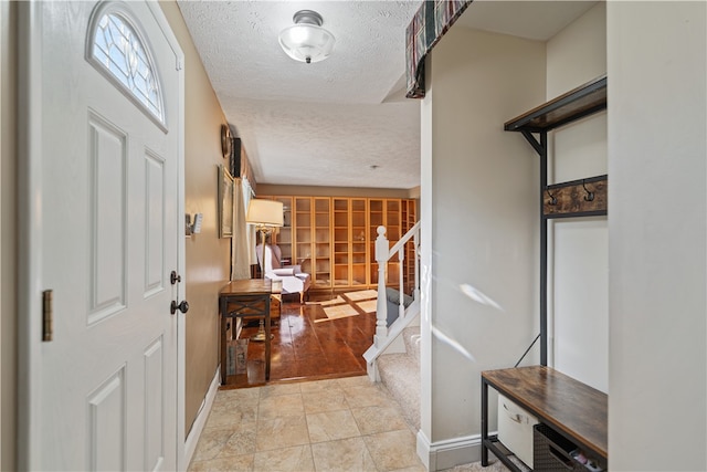 entryway with a textured ceiling