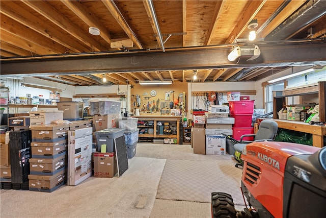 basement with a workshop area and carpet