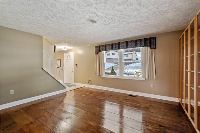 foyer with hardwood / wood-style floors and a textured ceiling