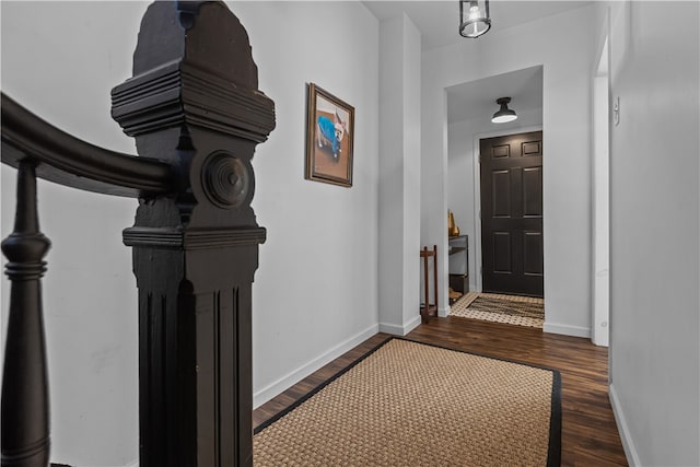 corridor with dark hardwood / wood-style flooring