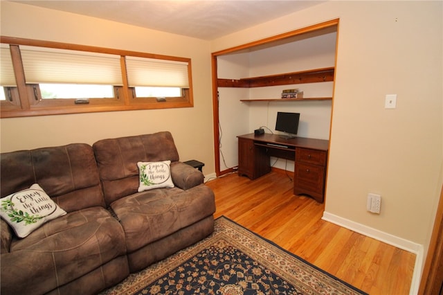 living room with hardwood / wood-style flooring and built in desk