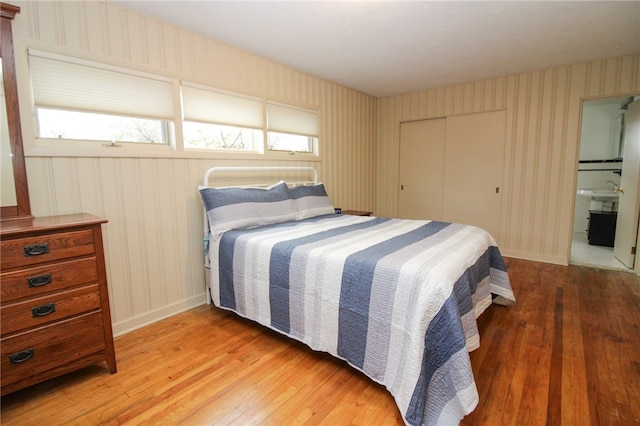 bedroom with a closet and hardwood / wood-style flooring