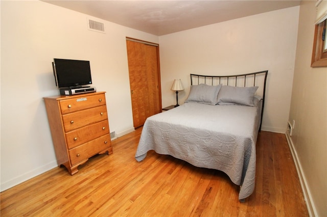 bedroom with a closet and light hardwood / wood-style flooring