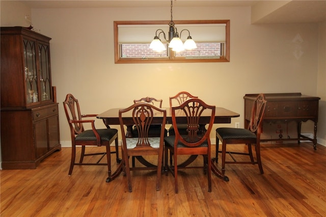 dining space featuring a chandelier and wood-type flooring