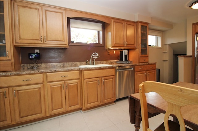 kitchen featuring stainless steel dishwasher, sink, light tile patterned flooring, and plenty of natural light