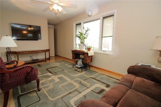 living room featuring hardwood / wood-style floors and ceiling fan