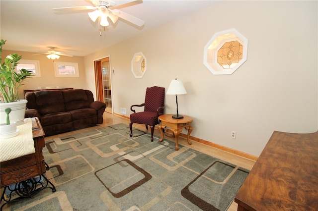 living room featuring hardwood / wood-style floors and ceiling fan