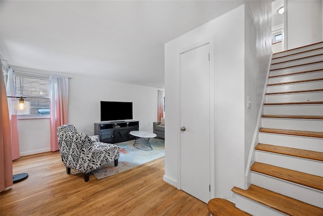 staircase with hardwood / wood-style floors