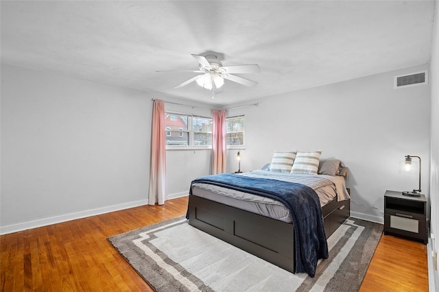 bedroom with wood-type flooring and ceiling fan