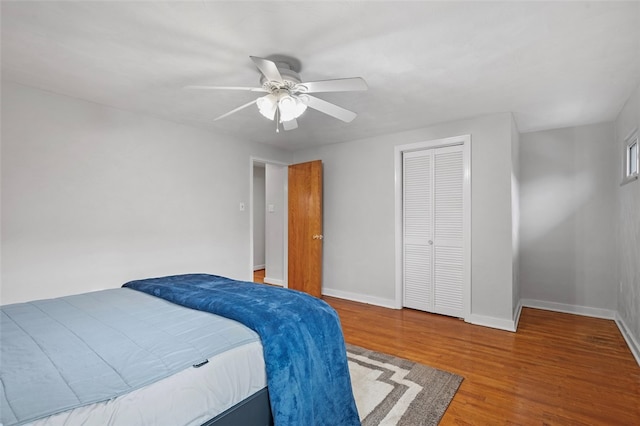 bedroom featuring ceiling fan, a closet, and wood-type flooring