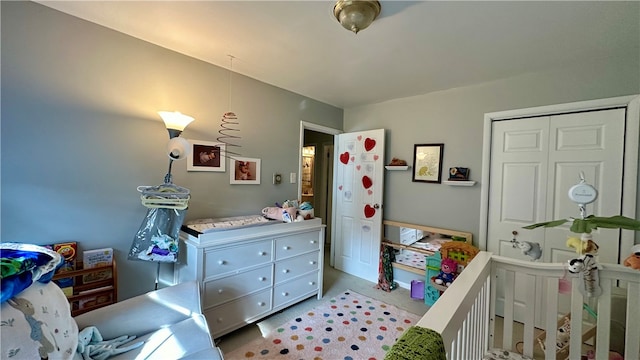 bedroom featuring a closet and a nursery area