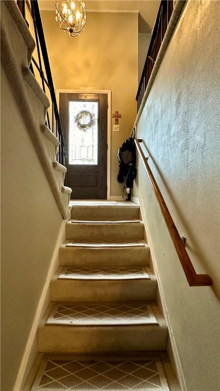 stairs with an inviting chandelier