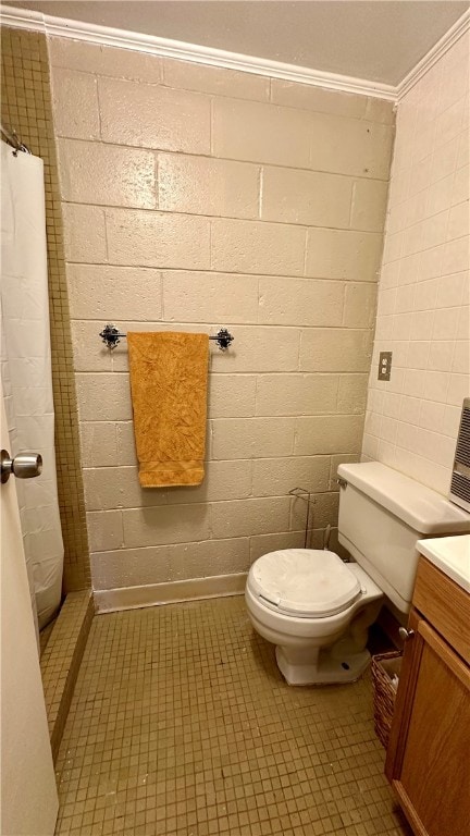 bathroom featuring walk in shower, tile patterned flooring, crown molding, toilet, and vanity