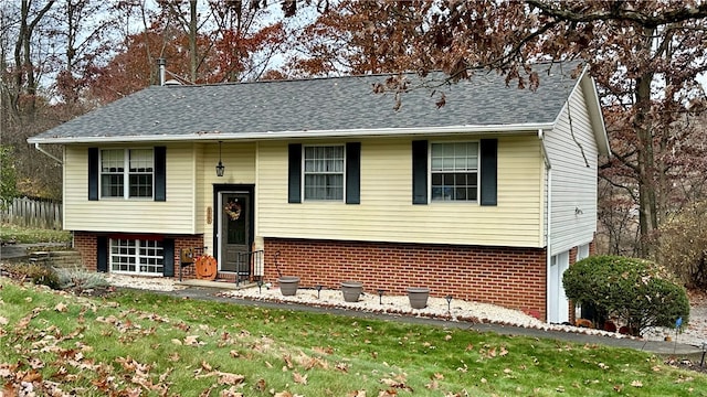 split foyer home featuring a garage and a front lawn