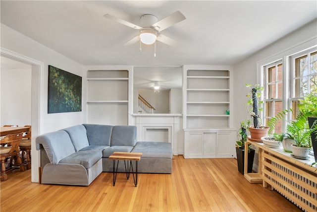 living room featuring light hardwood / wood-style floors and ceiling fan