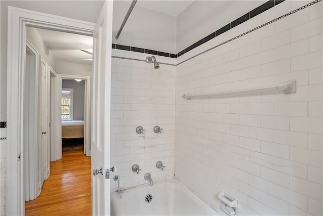 bathroom featuring hardwood / wood-style flooring and tiled shower / bath combo