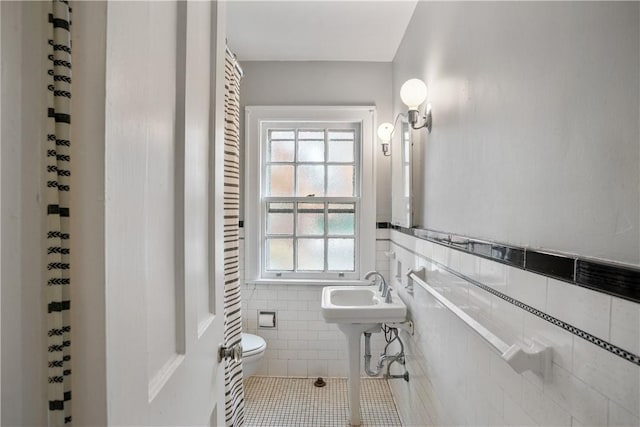 420 Sulgrave Rd, Mt Washington, PA 15211 - bathroom with tile walls, toilet, tile patterned flooring, and a wainscoted wall