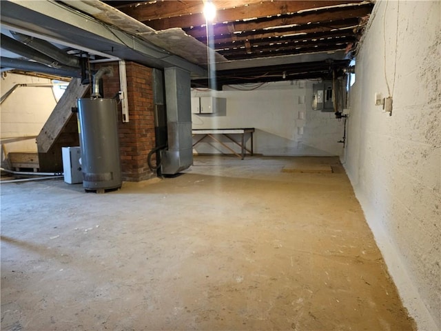 basement featuring water heater and electric panel