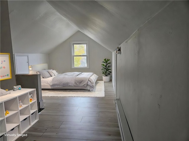 bedroom with lofted ceiling and dark hardwood / wood-style floors