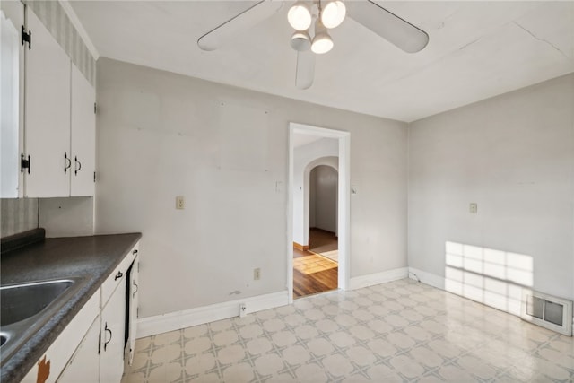 kitchen featuring white cabinets, light hardwood / wood-style flooring, sink, and ceiling fan