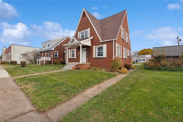 view of front of house with brick siding and a front yard