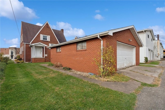 view of front of home featuring brick siding, a front lawn, a garage, and driveway