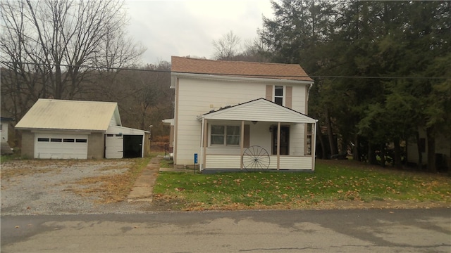 view of front of property featuring a garage and an outdoor structure