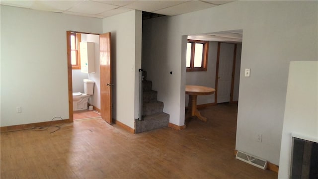 spare room featuring hardwood / wood-style floors and a paneled ceiling