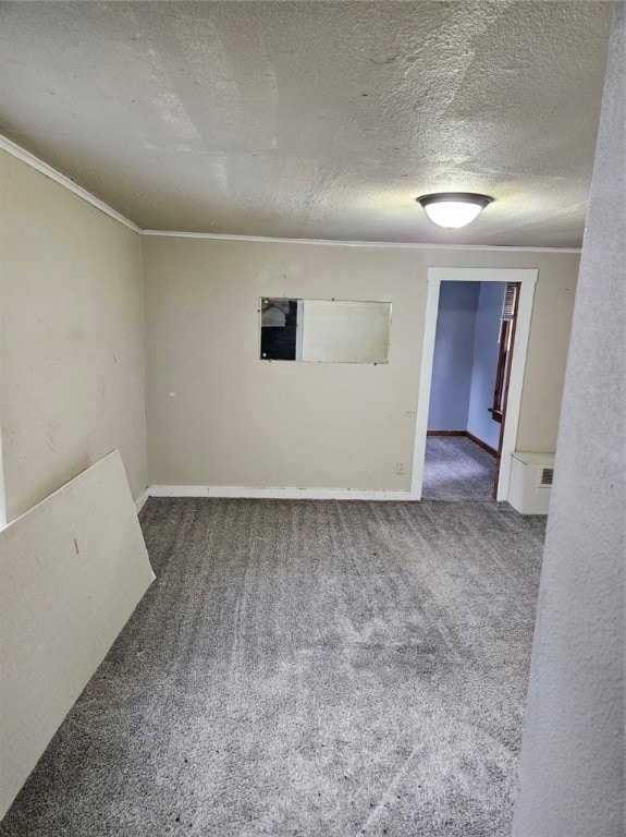 carpeted empty room featuring a textured ceiling