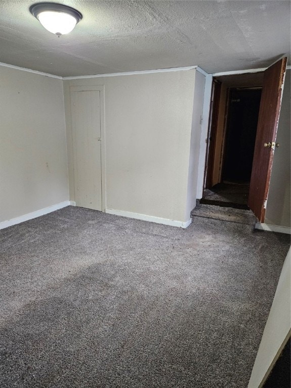 carpeted empty room with a textured ceiling