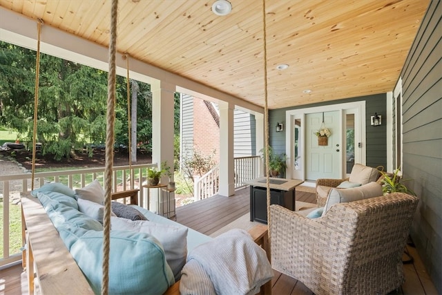 sunroom / solarium with lofted ceiling and wooden ceiling