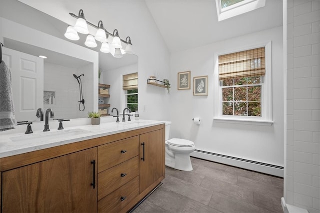 bathroom with a wealth of natural light, a baseboard radiator, vanity, and lofted ceiling with skylight