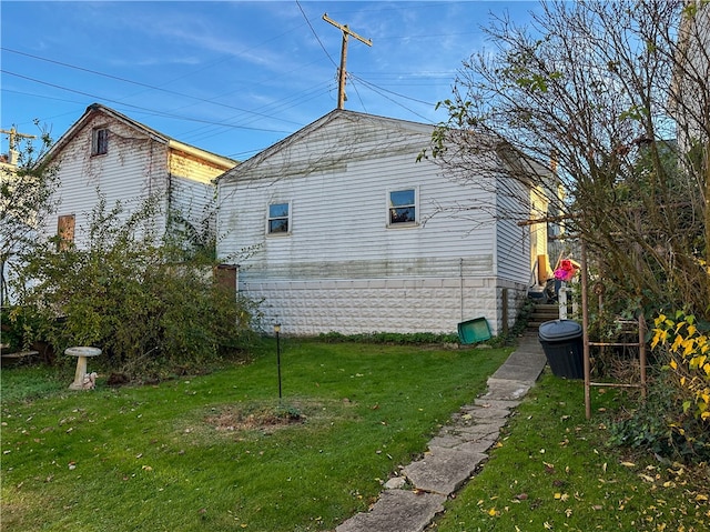 view of property exterior featuring a lawn