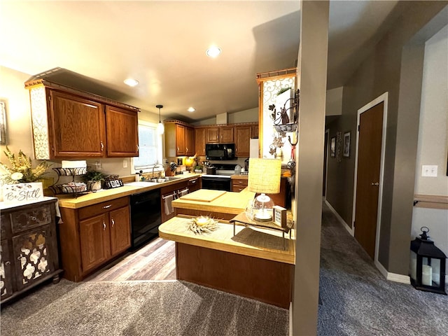 kitchen featuring sink, light colored carpet, hanging light fixtures, and black appliances