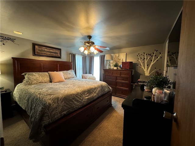 bedroom with ceiling fan and light carpet