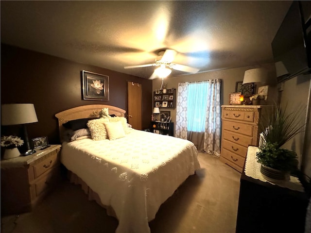 carpeted bedroom with ceiling fan and a textured ceiling