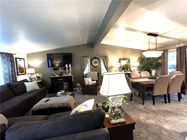 living room with carpet, vaulted ceiling with beams, and a fireplace