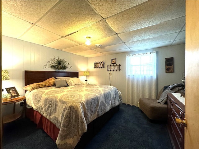 carpeted bedroom featuring a paneled ceiling