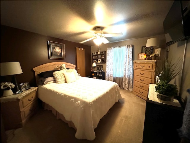 carpeted bedroom with a textured ceiling and ceiling fan