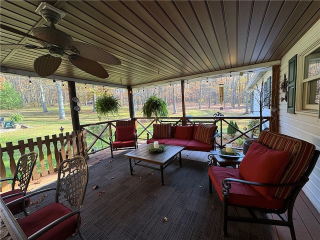 wooden terrace featuring ceiling fan, a yard, and an outdoor hangout area