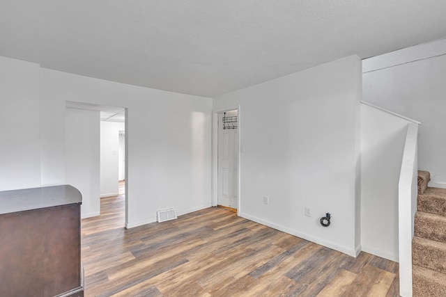 spare room featuring dark wood-type flooring