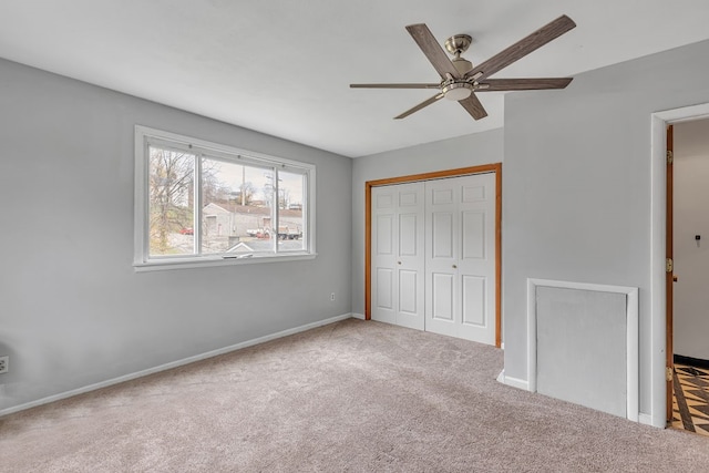 unfurnished bedroom with ceiling fan, a closet, and light colored carpet