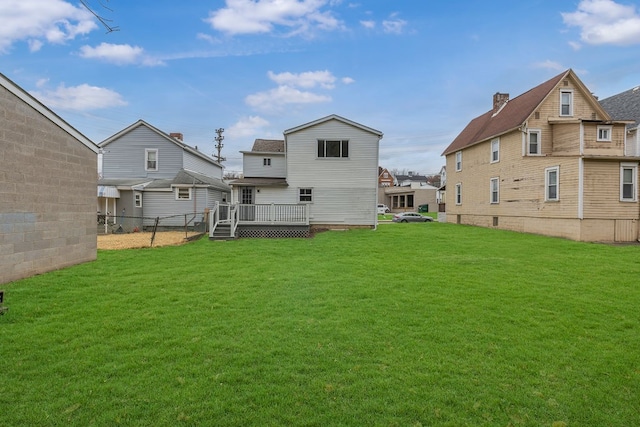 back of house featuring a yard and a wooden deck