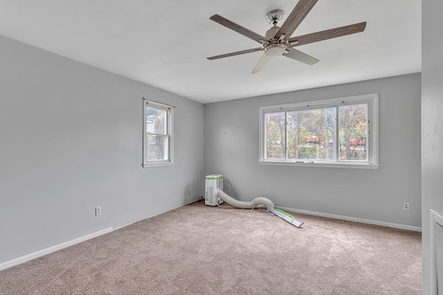 empty room with ceiling fan and carpet floors