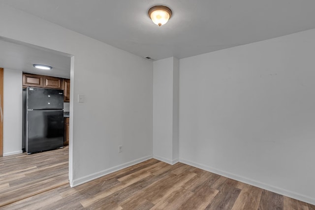 spare room featuring light hardwood / wood-style flooring