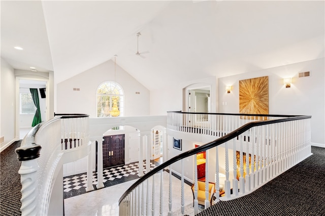 hall with lofted ceiling and carpet