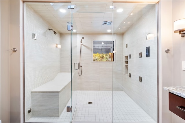 bathroom with an enclosed shower and vanity