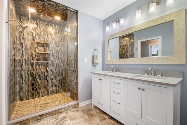 bathroom featuring a shower with door and vanity