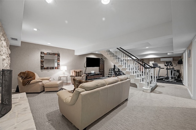 carpeted living room with a wall mounted AC